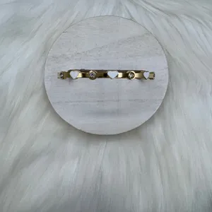 This chic bracelet showcases a beautiful gold finish with delicate white heart d thumbnail 5