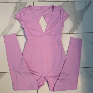 FREE PEOPLE MOVEMENT Pink bodysuit with cutout detail in back Size Small thumbnail 1