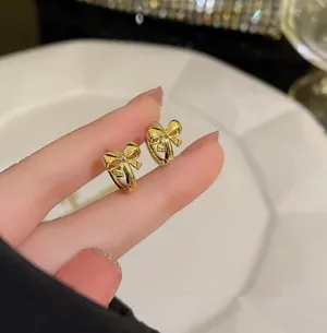 Gold Bow Hoops Earrings thumbnail 2