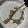 18k Gold multi charm bracelet with adjustable chain
