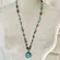 Blue and gold tone beaded long teardrop pendant necklace