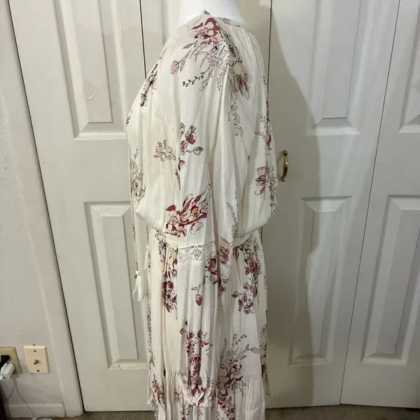 The American Rag Long Sleeve Lace Up Bodice Floral Dress in Cream is a stylish and versatile option for women. This fit & flare dress features a floral pattern in cream, pink, and white, making it perfect for various occasions such as travel, weddings, parties, or casual outings. The long sleeves and lace-up bodice add a touch of elegance, while the short dress length adds a trendy flair. Made from a blend of rayon, cotton, polyester, and linen, this dress offers both comfort and style for women in size M. - Image 3