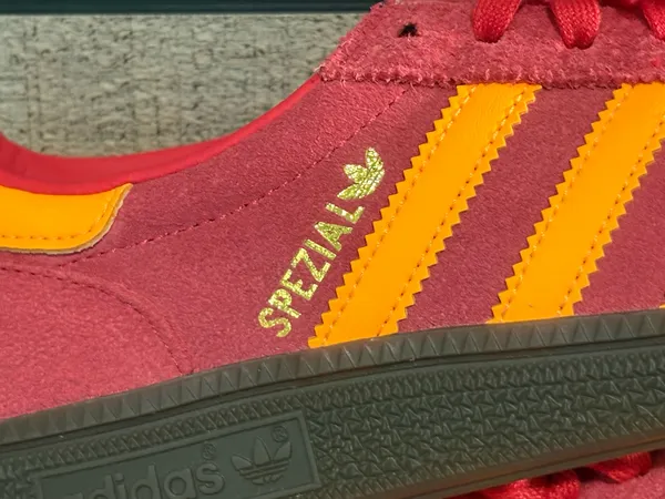 Adidas handball poles in a pretty red with light orange stripes - Image 2