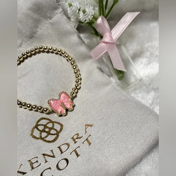Kendra Scott Haley Bow Gold Stretch Bracelet featuring a custom-carved pink bow - Image 3