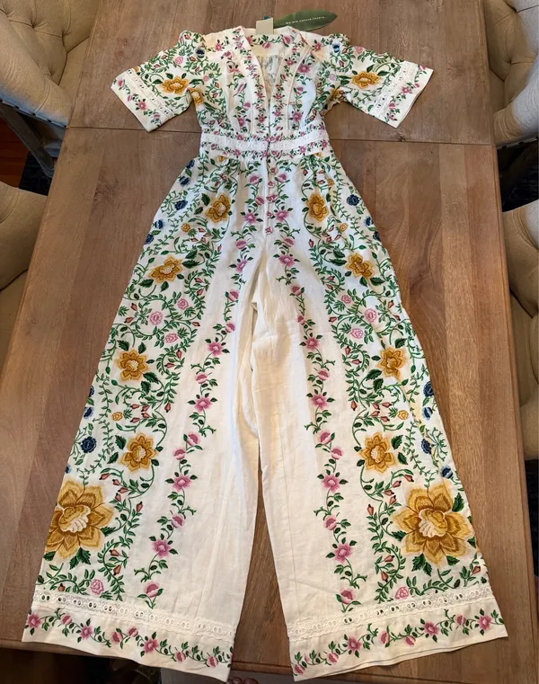 The Farm Rio Folk Floral Jumpsuit features a vibrant print with short sleeves, a V-neckline, and a relaxed, wide-leg silhouette. - Image 2