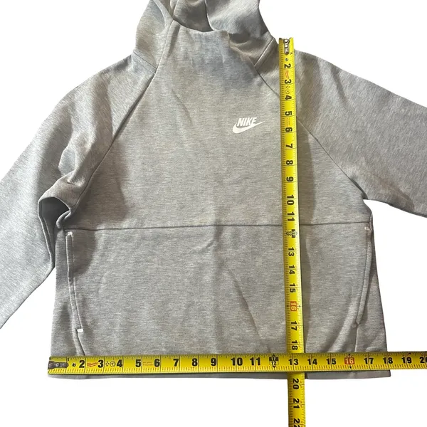 Nike Gray Minimalist Hoodie XS Y2K Athleisure Streetwear Description: Soft gray Nike hoodie with embroidered logo and kangaroo pocket. Perfect minimalist, gorpcore, streetwear, gym, and casual layering essential. Pre-owned Condition: Excellent Flaws: No significant flaws observed. Stored: Model created by AI. NikeHoodie Streetwear Athleisure MinimalistStyle Gorpcore HeatherGray Pullover LogoHoodie Layering Y2K - Image 7