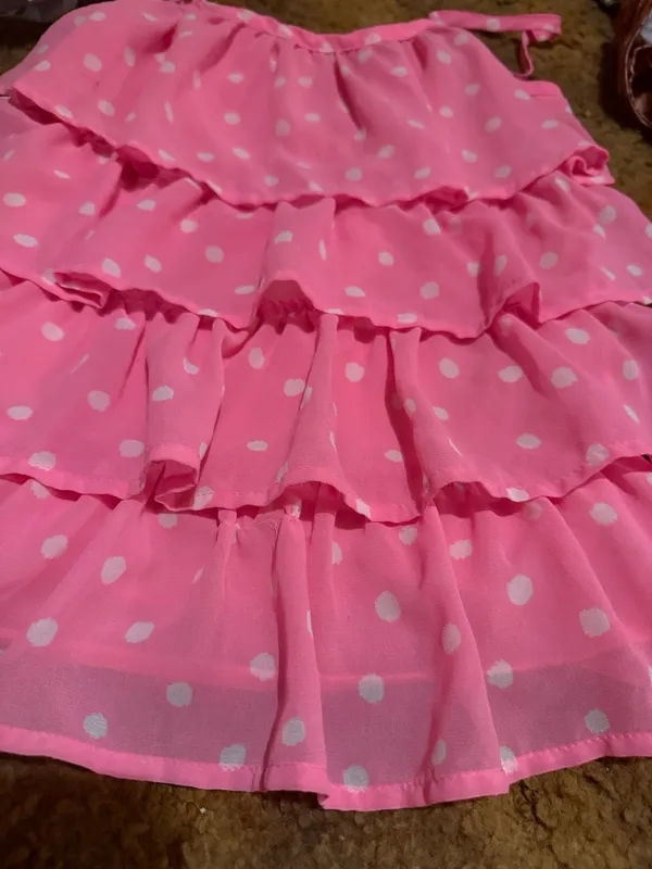 Lightweight pink tank with white polka dots. Features layered ruffle tiers and thin adjustable straps. Flows and feminine silhouette. Great for warm-weather styling. - Image 3
