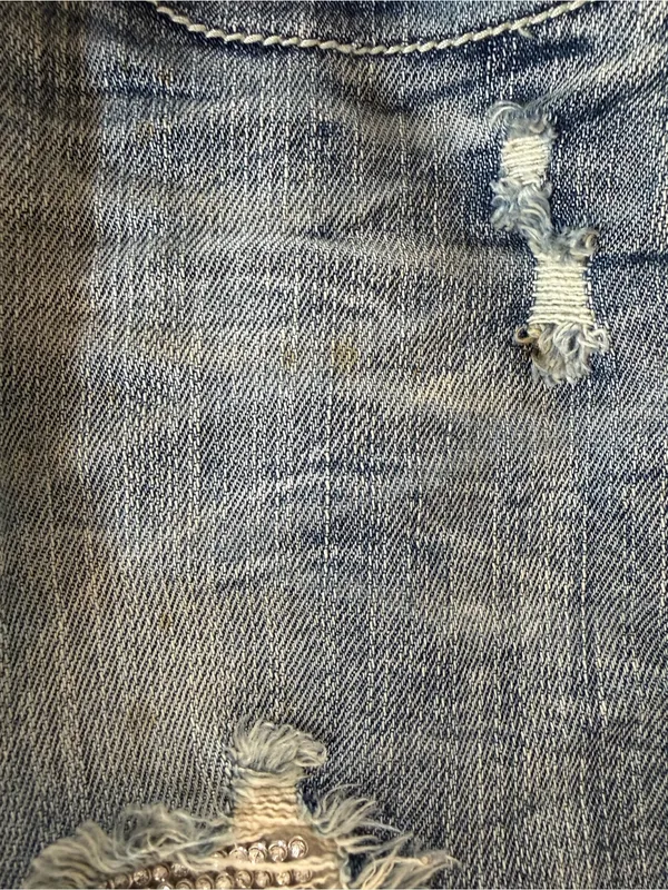 Machine distressed crystal embellished low rise denim jeans - Image 12