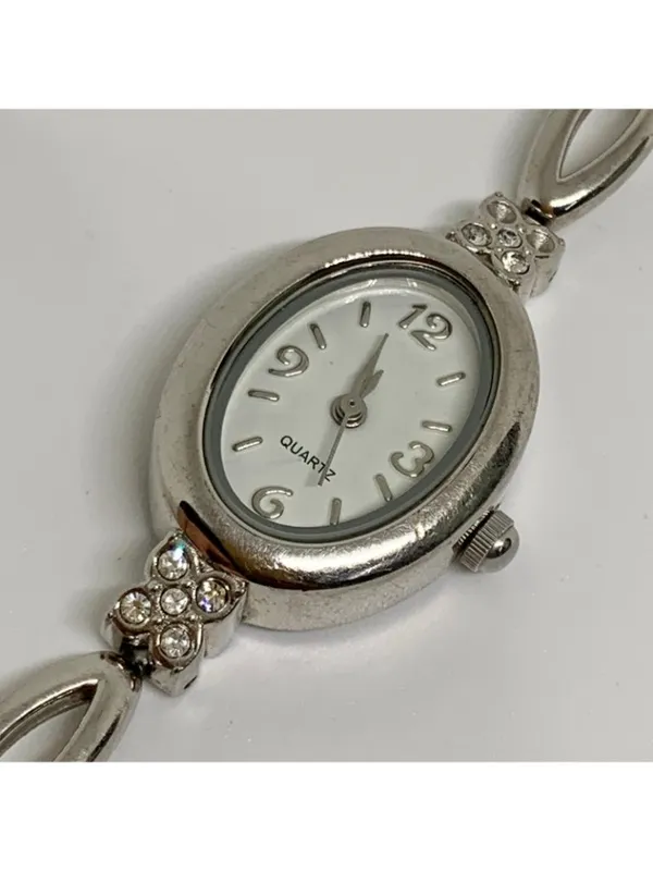 Silver tone women’s quartz analog watch 19mm oval white dial rhinestones running - Image 2
