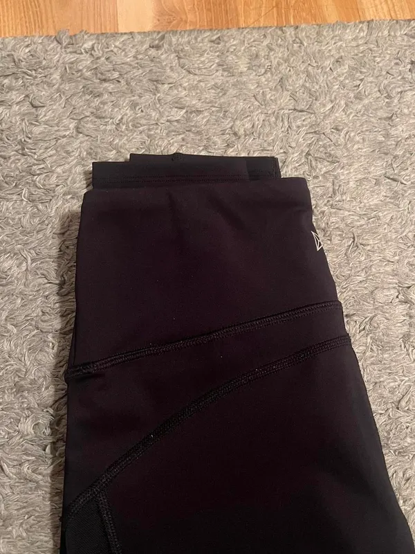 Black stretchy Yvette leggings with mesh design on outer thighs and ankles #activewear No flaws The lighting makes it look a little brown but they are plain black leggings I am a 26 in waist and 5'6" for reference - Image 5