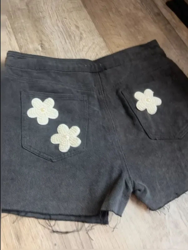 POL black denim skort features distinctive pearl-embellished flower details - Image 7