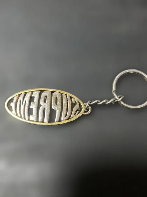 Supreme Two-Tone Oval Logo Keychain — Silver & Gold - Image 2