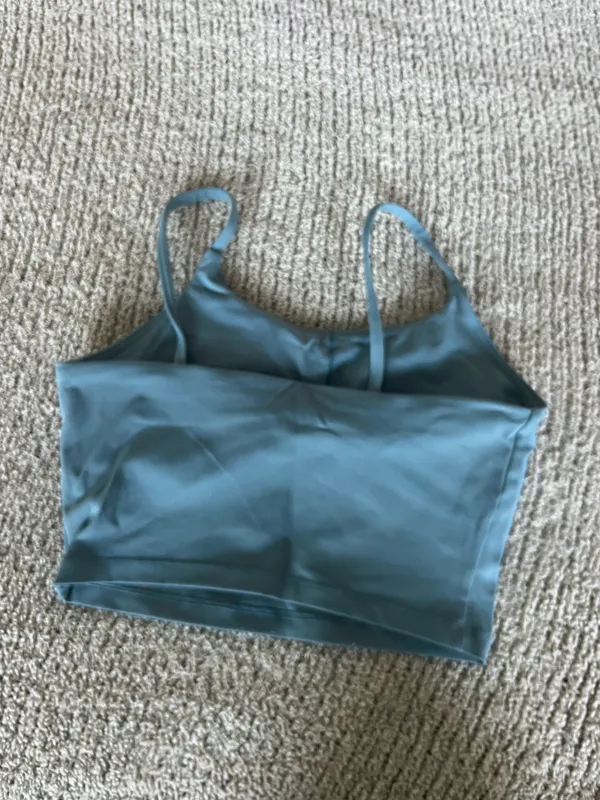 Amazon The Women's Blue Square Neck Activewear Tank Top is a stylish and comfortable piece perfect for active women. With its sleeveless design and spaghetti straps, this camisole features a square neckline for added versatility. Made for activewear occasions, this solid blue tank in size S offers a chic and practical option for women looking for a blend of style and functionality in their wardrobe. - Image 2