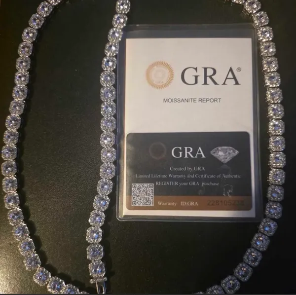 Make a statement with this iced-out cushion-cut tennis necklace, featuring rows of brilliant, sparkling stones set in a classic tennis-chain design. The cushion-shaped stones give it a bold, clean look while creating plenty of shine from every angle. ✨ Features: * 💎 Cushion-cut stone design * ❄️ Fully iced-out, high-shine appearance * 🔗 Classic tennis necklace style * ✨ Eye-catching sparkle in natural and flash lighting * 👑 Bold luxury-inspired look * 🖤 Great for everyday wear, going out, parties, photoshoots, or stacking with other chains * 🎁 Makes a great gift for anyone who loves statement jewelry - Image 2