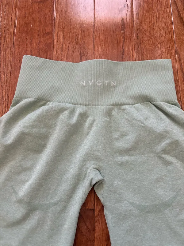 NVGTN Sage Green Contour Seamless Shorts M bike shorts lightly worn Our signature seamless material is now available in shorts! These shorts feature a conservative length that won’t be interrupted through movement along with a form flattering waistband that offers slight compression. This buttery soft and breathable material will not only feel weightless on your body, but will move with and not against you. Pair these with its matching seamless top or bra to complete the look. - Nylon and spandex - Fabric feels… lightweight, soft, stretchy - High waisted - Compressive waistband contour shaping - Image 6