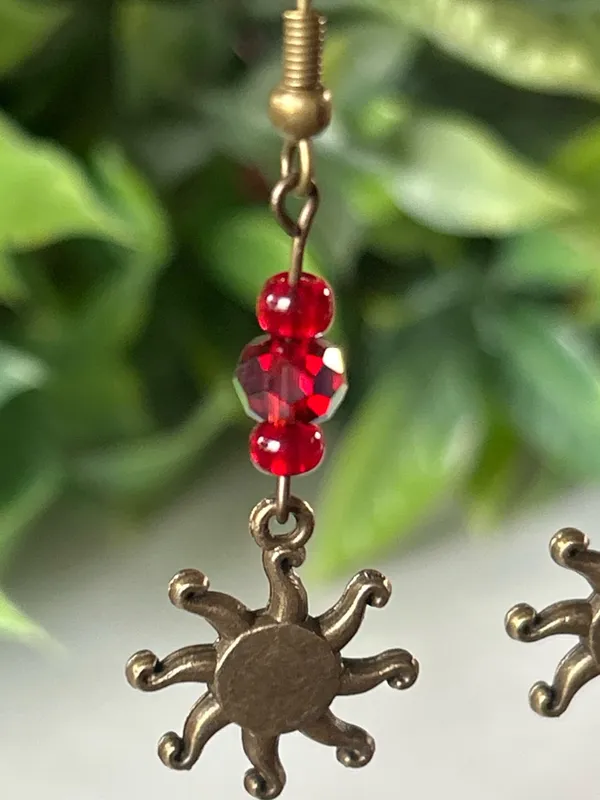 Handmade brass sun earrings with red crystal beads - Image 2