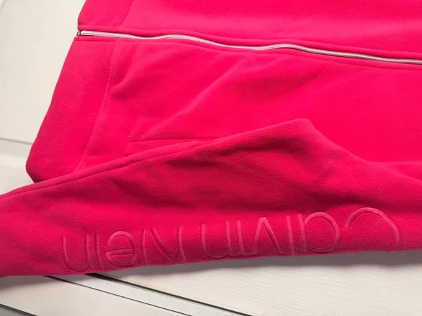 Calvin Klein fleece teddy jacket in vibrant hot pink. Full-zip front with stand collar. Side pockets for hands. Subtle branded detail on the sleeve. Soft, cozy finish for everyday wear. - Image 4