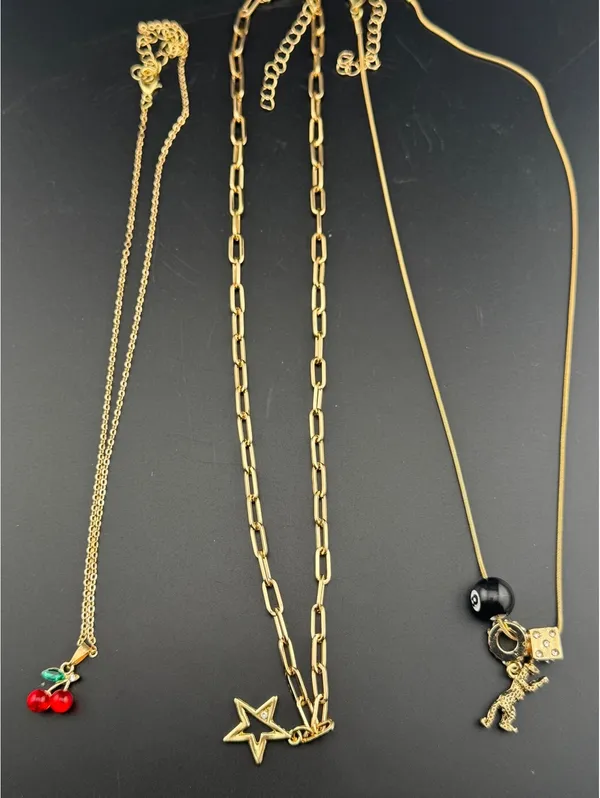 Set of 3 Gold Tone Charm Necklaces with Star, Dinosaur, Dice - Image 3