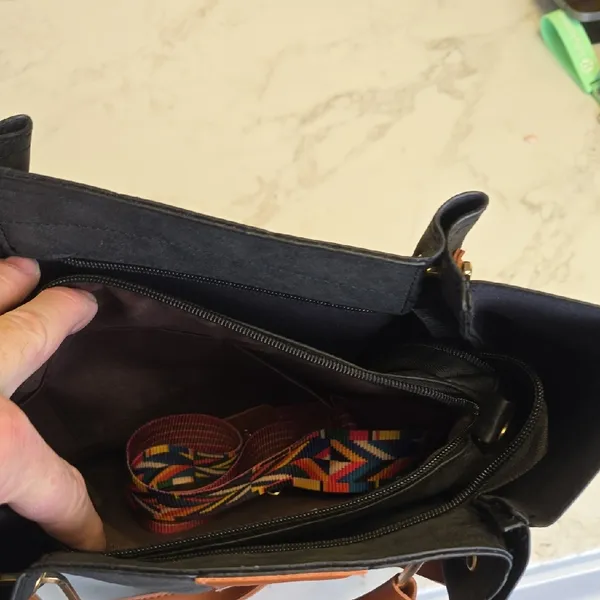 Elegant Black Tote Bag with Brown Handles and Colorful Pattern - Image 2