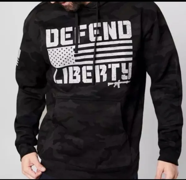 Howitzer "Defend Liberty" Black Camo Hoodie Elevate your casual wear with this rugged and patriotic Howitzer "Defend Liberty" Hoodie. Featuring a stealthy black multicam (camo) pattern, this hoodie is designed for those who value both style and a strong message of freedom. Constructed with high-quality, durable fabric, it offers a comfortable fit perfect for outdoor adventures, range days, or daily wear. Product Features: • Brand: Howitzer Manufacturing Co. • Design: Bold "DEFEND LIBERTY" distressed graphic with the American flag and an AR-15 silhouette on the front. • Back Detail: A vertical "DEFEND LIBERTY" spine graphic for a unique look from every angle. • Sleeve Detail: Features the Howitzer brand American flag patch on the sleeve. • Pattern: Modern black/dark grey camouflage. • Style: Pullover with adjustable drawstring hood and a spacious kangaroo front pocket. - Image 8