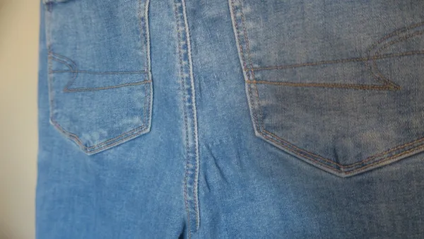 American Eagle Outfitters next level stretch super hi-rise flare jeans in medium wash blue size 4. - Image 13
