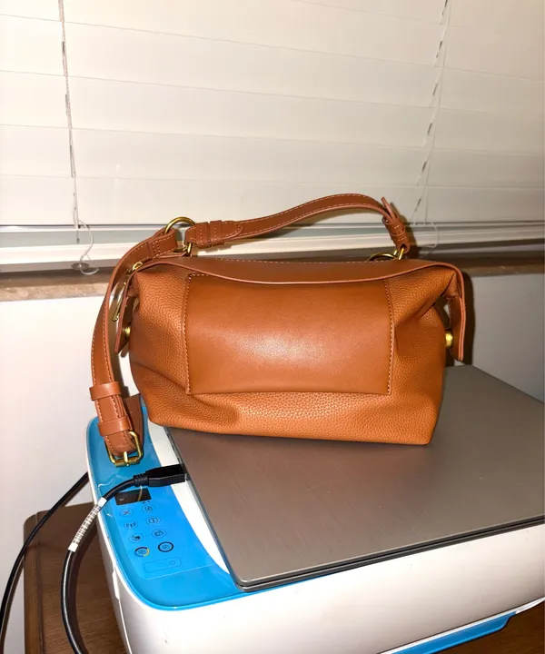 The Free Assembly brown bag features a faux leather structure with top handles and a removable crossbody strap. - Image 6
