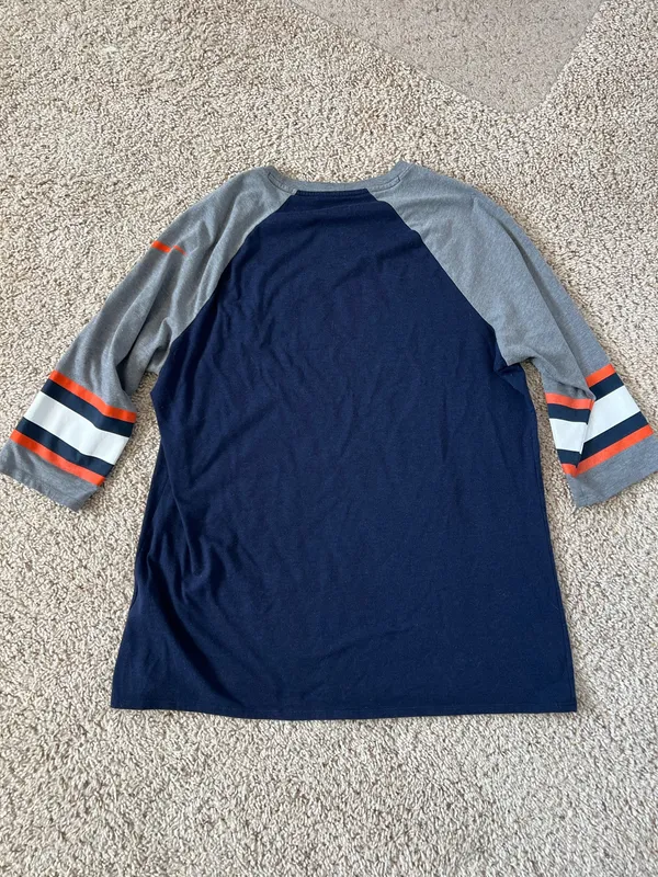 Denver Broncos logo on the chest. Navy body with gray raglan sleeves. Orange and white stripe accents on sleeves. Lightweight fan tee for game days. Nike. Size XL - Image 4