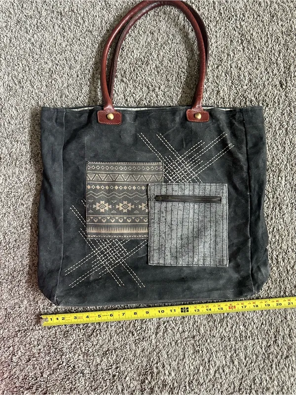 Mono B Black Canvas Tote with Brown Handles and Patterned Front Pockets - Image 2