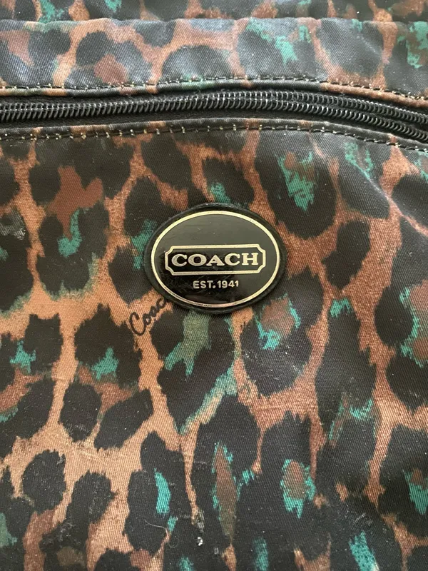 COACH-CHEETAH PRINT NYLON CROSSBODY BAG NO H1376-F77479 Coach crossbody with bold leopard print. Compact silhouette with adjustable shoulder strap. Front zip pocket and main compartment for essentials. Gold-tone logo plaque and hardware accents, front zip pocket, back slip pocket with magnetic closure, adjustable strap, great condition Measures:19.5x9.5 inches - Image 9