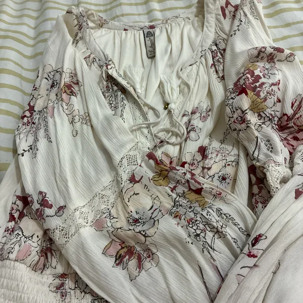 The American Rag Long Sleeve Lace Up Bodice Floral Dress in Cream is a stylish and versatile option for women. This fit & flare dress features a floral pattern in cream, pink, and white, making it perfect for various occasions such as travel, weddings, parties, or casual outings. The long sleeves and lace-up bodice add a touch of elegance, while the short dress length adds a trendy flair. Made from a blend of rayon, cotton, polyester, and linen, this dress offers both comfort and style for women in size M. - Image 7