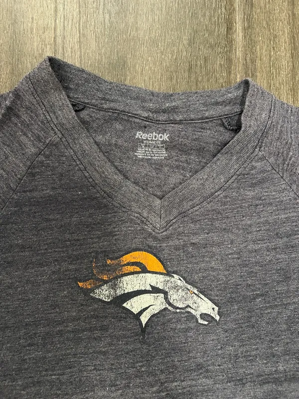 Soft heathered navy V-neck tee. Front Denver Broncos logo in white and orange. Lightweight, casual team tee. Great for everyday wear. Reebok size small - Image 2