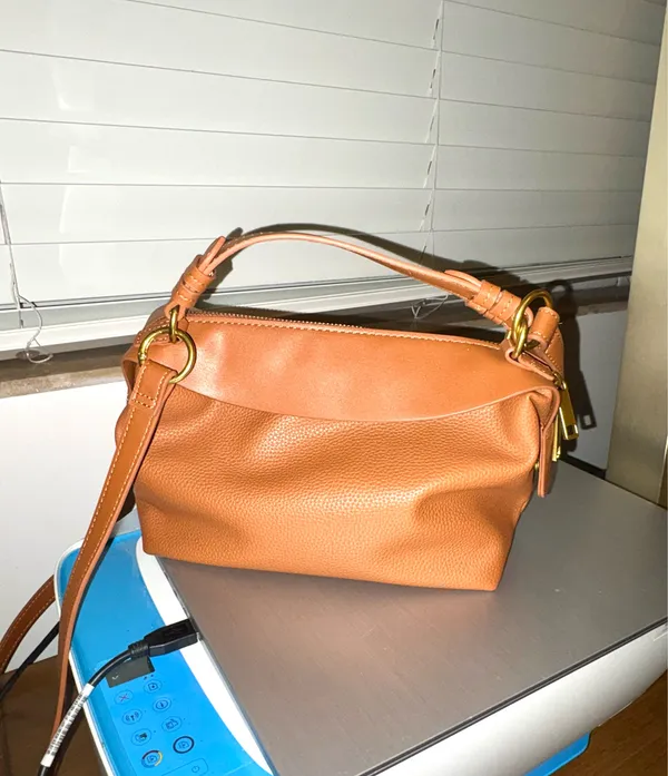 The Free Assembly brown bag features a faux leather structure with top handles and a removable crossbody strap. - Image 4
