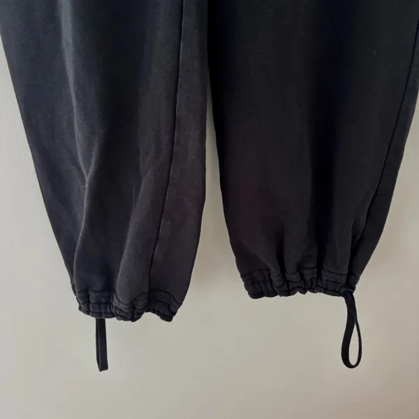 Black Nike sweatpants with drawstring waist and adjustable cuffs - Image 2