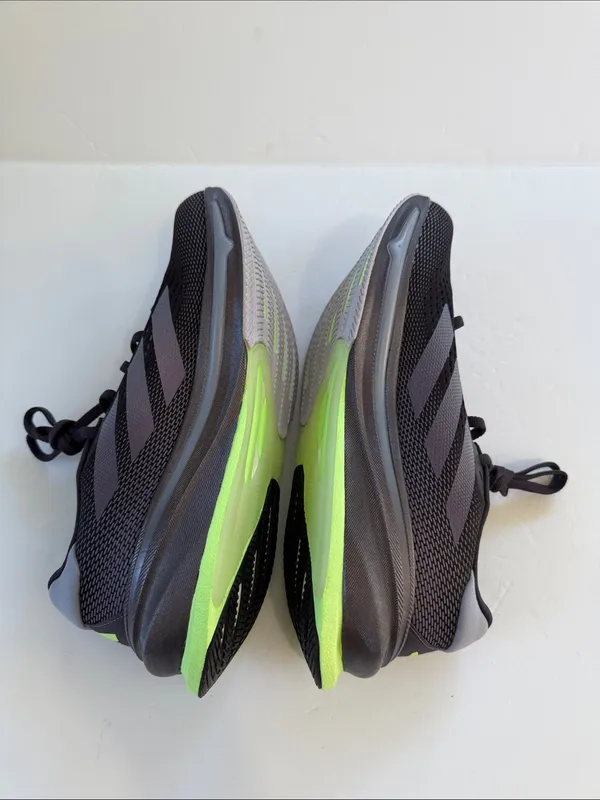 adidas women’s Black Athletic Shoes with White Stripes and Neon Green Accent - Image 9