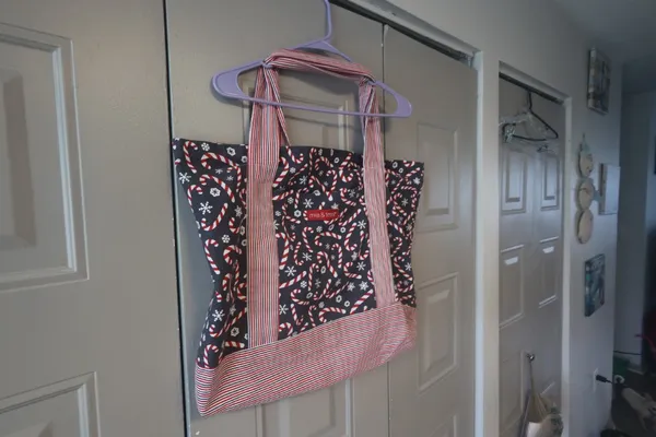 Mia and Tess candy cane and snowflake Christmas tote in black, red and white. - Image 3