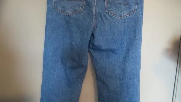 American Eagle Outfitters next level stretch super hi-rise flare jeans in medium wash blue size 4. - Image 11