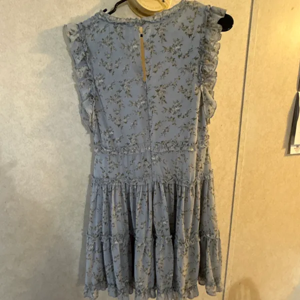 This is a light blue floral mini dress by She+Sky featuring a deep V-neckline and a tiered ruffled hem. - Image 2