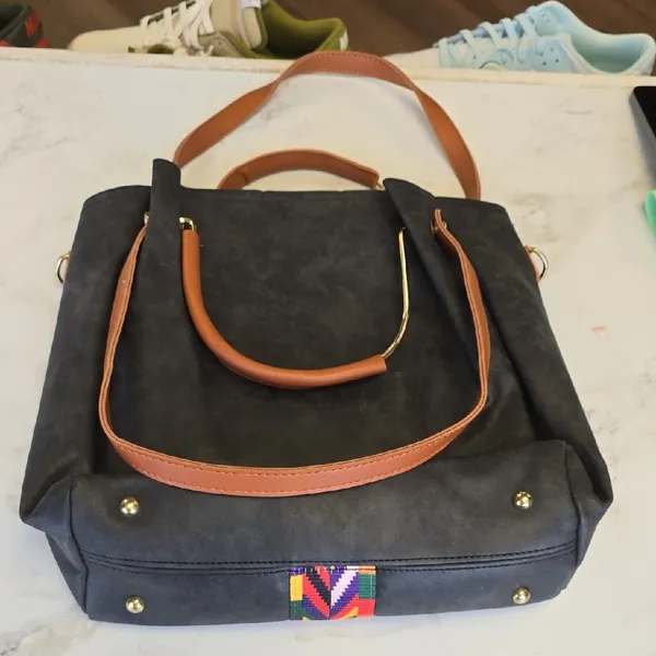 Elegant Black Tote Bag with Brown Handles and Colorful Pattern - Image 3