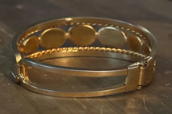 Gold tone open hinged bangle with oval black stones - Image 5
