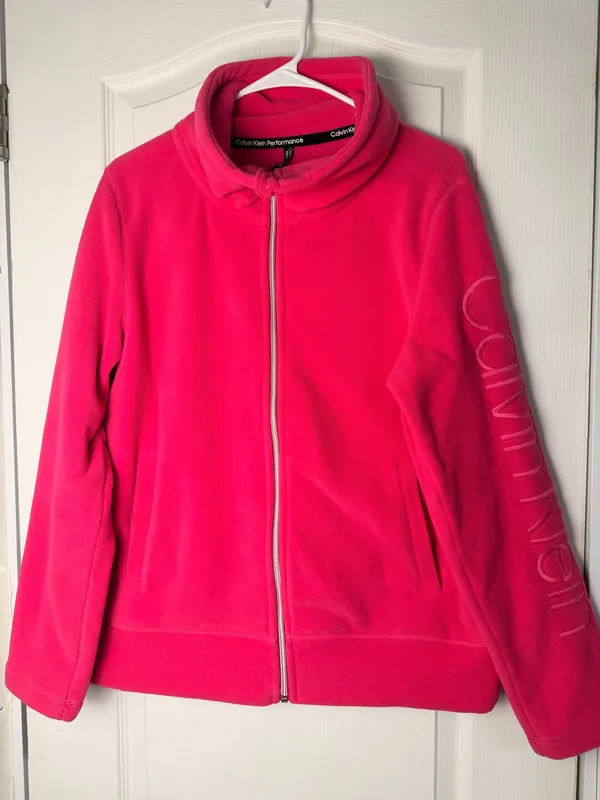Calvin Klein fleece teddy jacket in vibrant hot pink. Full-zip front with stand collar. Side pockets for hands. Subtle branded detail on the sleeve. Soft, cozy finish for everyday wear. - Image 3