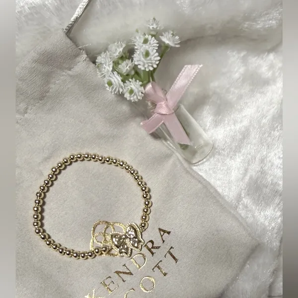 Kendra Scott Haley Bow Gold Stretch Bracelet featuring a custom-carved pink bow - Image 4