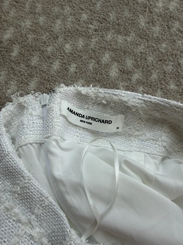 Chic white mini skirt with textured horizontal detailing. Slim, flattering silhouette. Easy to pair with tops or jackets for polished looks. - Image 3