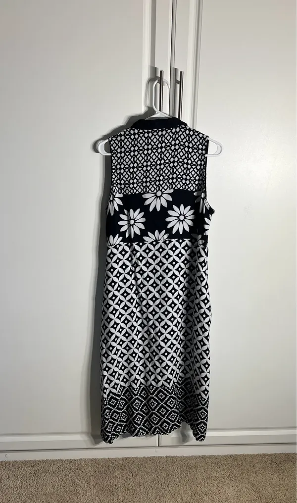 Chic sleeveless black and white dress with bold floral and geometric patterns. Lightweight and breathable for comfortable all-day wear. Collared neckline adds a polished touch and pockets. Easy to style for casual or dressy occasions. BIBA size medium - Image 4