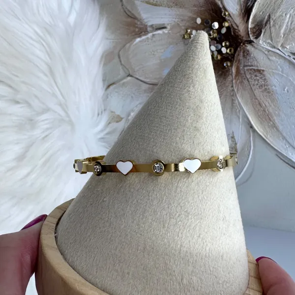 This chic bracelet showcases a beautiful gold finish with delicate white heart d - Image 3