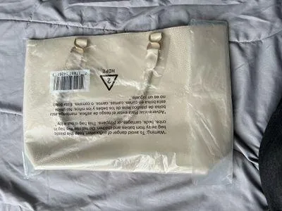 Ulta Beauty Tote Bag – Cream (New in packaging) Add a clean, elegant touch to your outfits with this beautiful tote! It comes in a super versatile cream/ivory shade, featuring a textured faux-leather finish and unique braided handles that give it a chic look. - Image 2