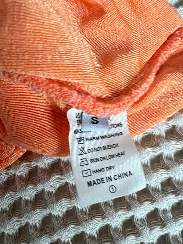 Amazon Bright orange one-shoulder top with soft ruched detailing. Lightweight, drapey fabric. Stylish single-shoulder silhouette. Versatile for day or night outfits. - Image 3