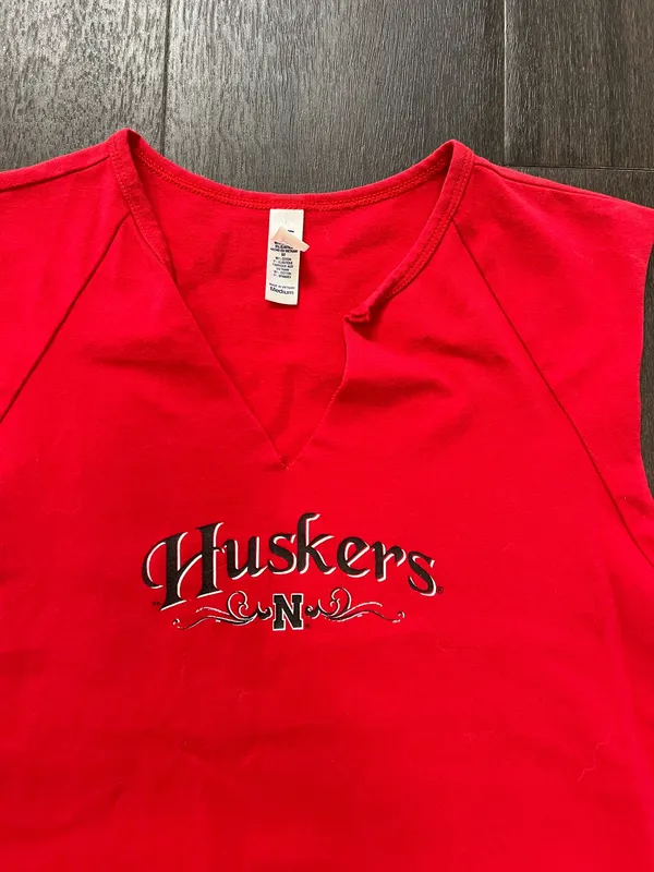 Bella Canvas Comfortable red sleeveless V-neck top with Huskers chest logo. Soft, breathable fabric for everyday wear. Clean, fitted silhouette that layers easily. Machine washable for easy care. size medium - Image 4