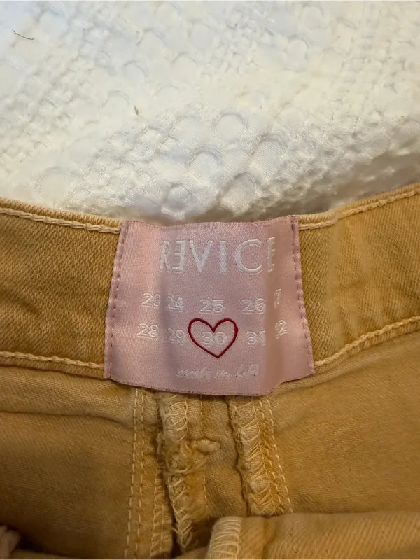REVICE High-Rise Frayed Hem Jean Shorts in Mustard - Image 2
