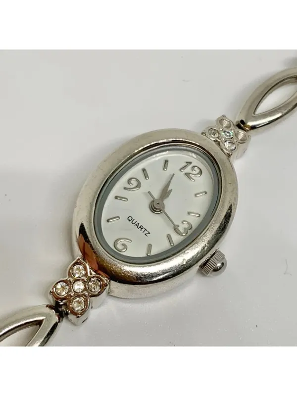 Silver tone women’s quartz analog watch 19mm oval white dial rhinestones running - Image 7