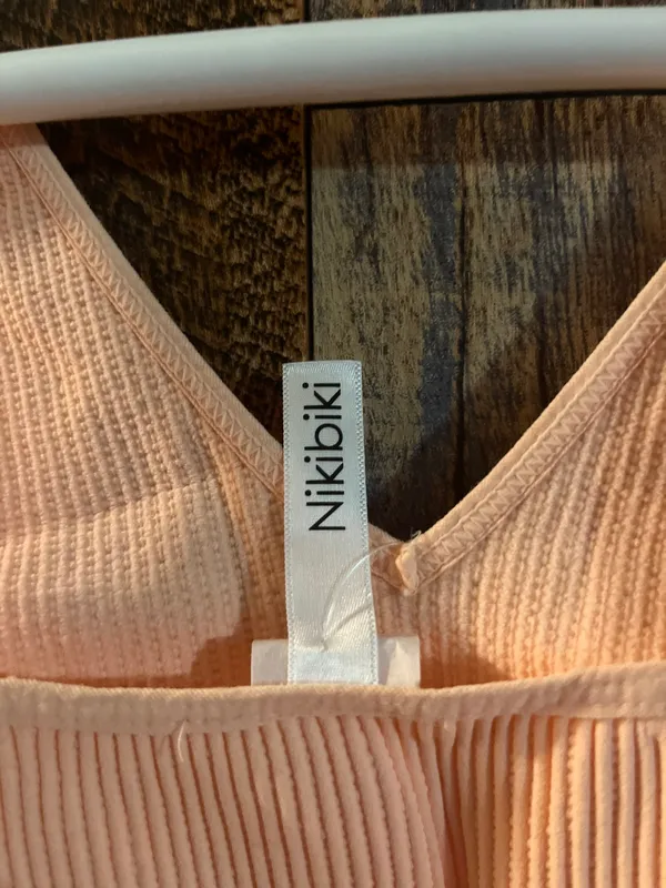 NIKIBIKI Women Seamless Plunge V-Neck Ribbed Crop Top, Made in U.S.A, One Size Elevate your style with this chic peach ribbed V-neck top. Perfect for any occasion. - Image 5